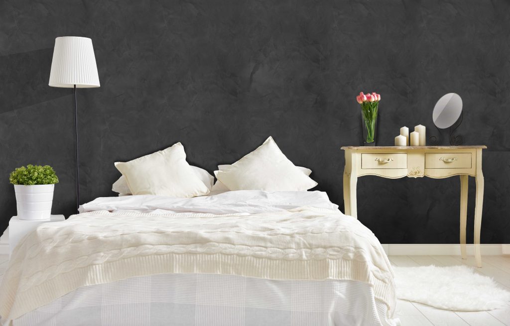 bedroom in soft light colors. big comfortable double bed in elegant classic bedroom